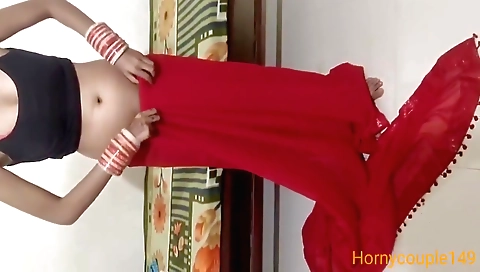 Indian brunette in a sexy dress stays in the bedroom
