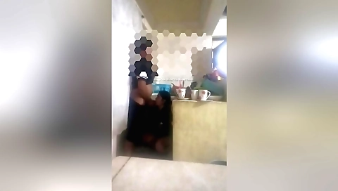 A brunette is getting her pussy fucked in the kitchen