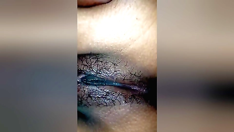 Indian girl takes off her clothes on the sofa in a hairy pussy video